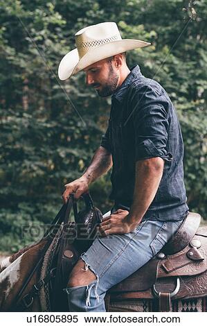 Cowboy on horseback in forest, cropped View Large Photo Image Stock Photography - Cowboy on horseback in forest, cropped. Fotosearch