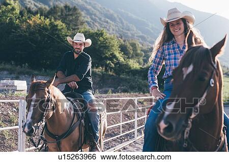 Cowgirl and boy on horseback in equestrian arena, portrait, Primaluna, Trentino-Alto Adige, Italy View Large Photo Image Stock Photograph - Cowgirl and boy on horseback in equestrian arena, portrait, Primaluna, Trentino-Alto Adige, Italy. Fotosearch