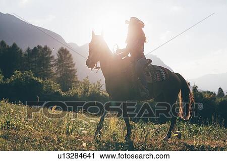 Cowgirl horse riding in field, backlit, Primaluna, Trentino-Alto Adige, Italy View Large Photo Image Stock Image - Cowgirl horse riding in field, backlit, Primaluna, Trentino-Alto Adige, Italy. Fotosearch