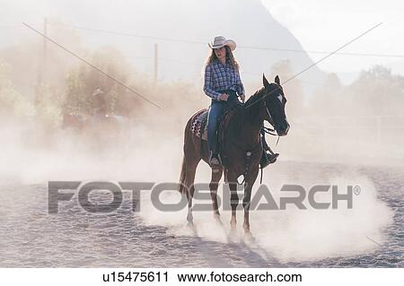 Cowgirl on horse in dusty equestrian arena, Primaluna, Trentino-Alto Adige, Italy View Large Photo Image Stock Image - Cowgirl on horse in dusty equestrian arena, Primaluna, Trentino-Alto Adige, Italy. Fotosearch