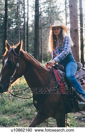 Cowgirl on horseback in forest, backlit portrait, Primaluna, Trentino-Alto Adige, Italy View Large Photo Image Stock Image - Cowgirl on horseback in forest, backlit portrait, Primaluna, Trentino-Alto Adige, Italy. Fotosearch
