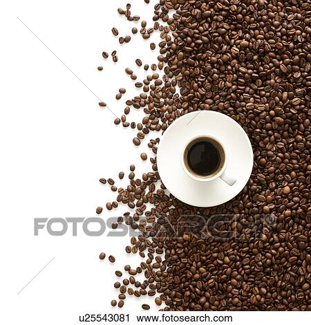 Stock Image - Cup of coffee and coffee beans, high angle view.. Fotosearch