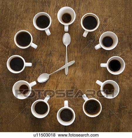 Stock Photo - Cups of coffee making the shape of a clock.. Fotosearch
