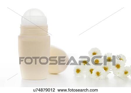 Stock Image - Deodorant and flowers, studio shot.. Fotosearch