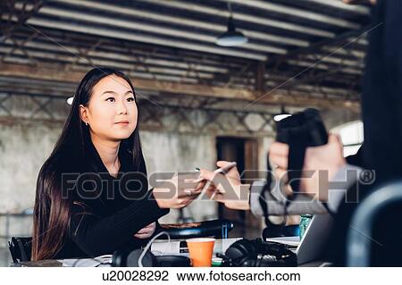Stock Image - Designers at work in studio. Fotosearch