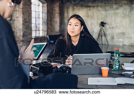 Stock Image - Designers at work in studio. Fotosearch
