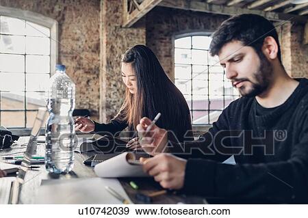 Stock Photo - Designers at work in studio. Fotosearch