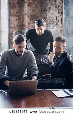 Stock Photography - Designers at work in studio. Fotosearch