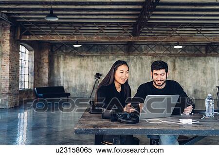 Stock Photography - Designers at work in studio. Fotosearch