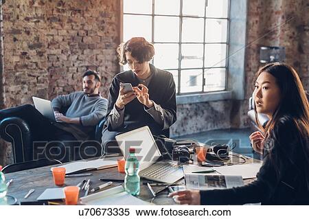 Designers brainstorming in communal space in studio View Large Photo Image Stock Photography - Designers brainstorming in communal space in studio. Fotosearch