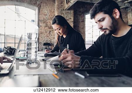 Designers brainstorming in studio View Large Photo Image Stock Image - Designers brainstorming in studio. Fotosearch