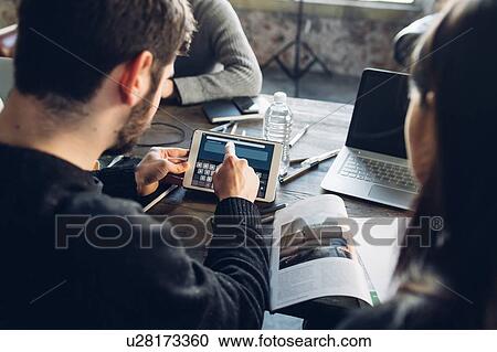 Stock Image - Designers brainstorming in studio. Fotosearch