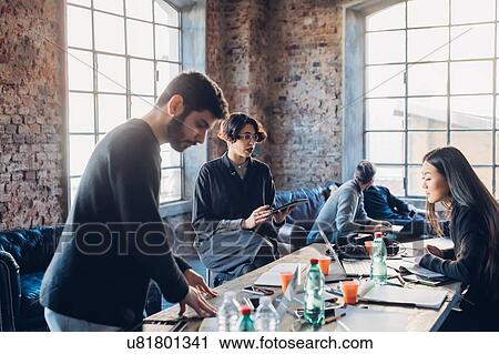 Designers brainstorming in studio View Large Photo Image Stock Image - Designers brainstorming in studio. Fotosearch