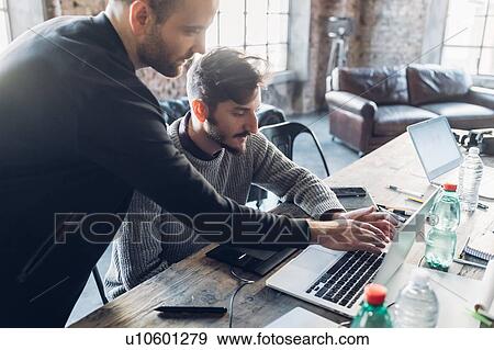 Stock Photo - Designers brainstorming in studio. Fotosearch