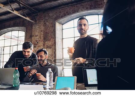 Stock Photo - Designers brainstorming in studio. Fotosearch