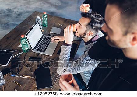 Stock Photo - Designers brainstorming in studio. Fotosearch