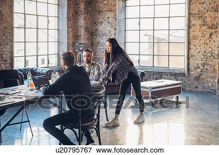 Designers brainstorming in studio View Large Photo Image Stock Photo - Designers brainstorming in studio. Fotosearch