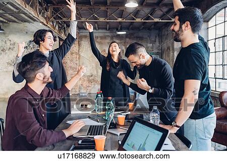 Stock Photo - Designers celebrating success in studio. Fotosearch
