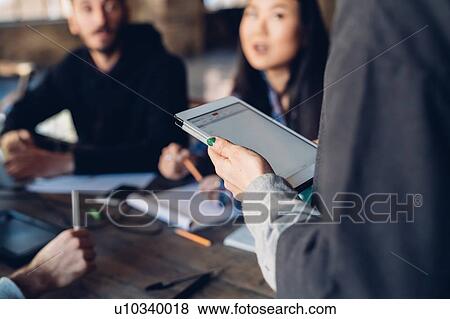 Stock Photo - Designers having meeting in studio. Fotosearch