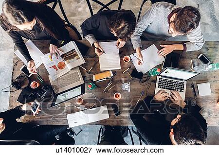 Stock Photo - Designers having meeting in studio. Fotosearch