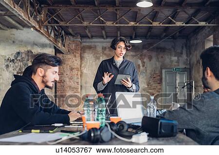 Stock Photo - Designers having meeting in studio. Fotosearch