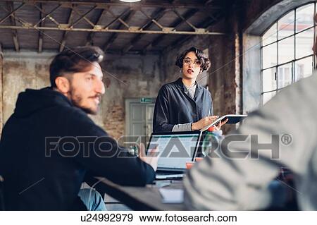 Stock Photo - Designers having meeting in studio. Fotosearch