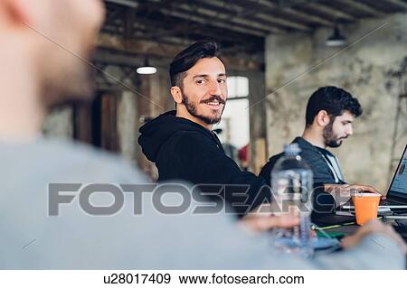 Stock Photo - Designers having meeting in studio. Fotosearch