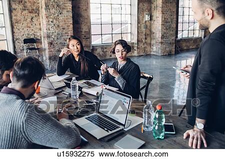 Stock Photography - Designers having meeting in studio. Fotosearch