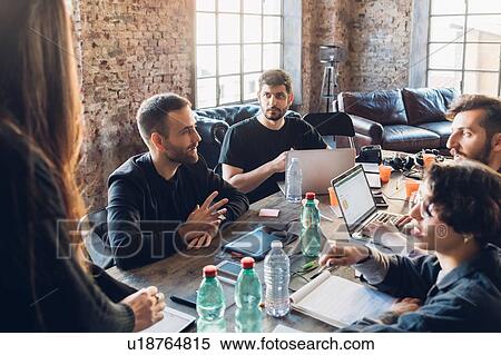 Stock Photography - Designers having meeting in studio. Fotosearch