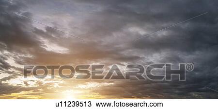 Stock Image - Dramatic sunset and sunrise sky.. Fotosearch