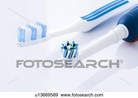 Electric and manual toothbrushes against a white background. View Large Photo Image Stock Photo - Electric and manual toothbrushes against a white background.. Fotosearch