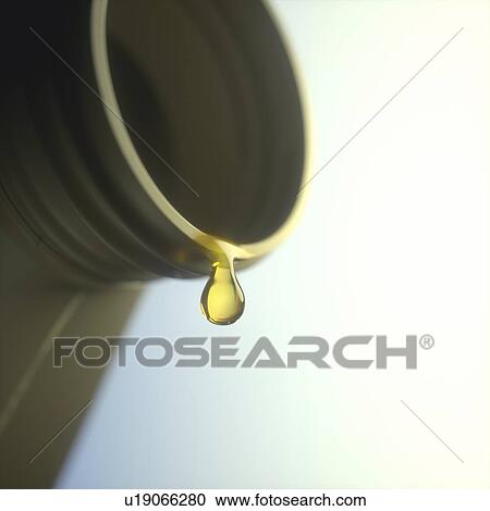 Stock Image - Engine oil dripping from a bottle, illustration.. Fotosearch