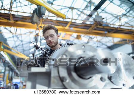 Engineer assembling gearbox in gearbox factory View Large Photo Image Stock Image - Engineer assembling gearbox in gearbox factory. Fotosearch