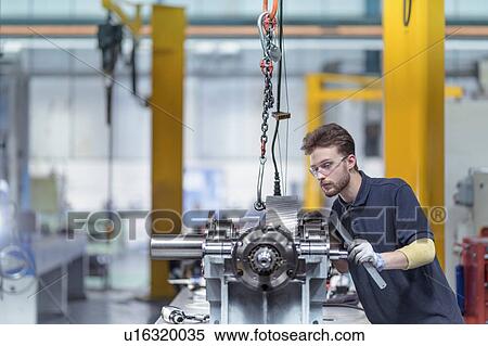 Stock Photography - Engineer assembling gearbox in gearbox factory. Fotosearch
