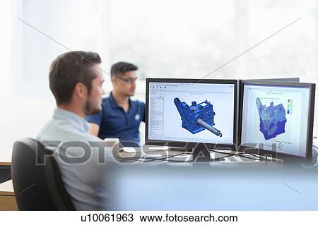 Stock Image - Engineers designing gearboxes using computer aided design (CAD) software in gearbox factory. Fotosearch