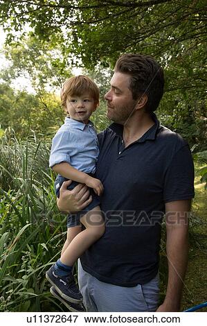 Stock Photo - Father and child in park. Fotosearch