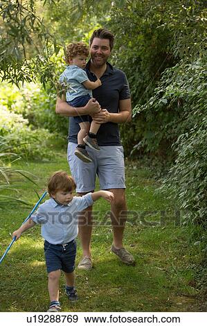 Stock Photo - Father and children in park. Fotosearch