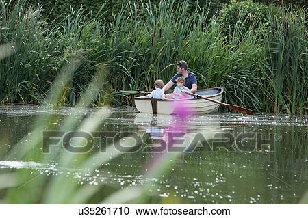 Father and children on boat ride in lake View Large Photo Image Stock Image - Father and children on boat ride in lake. Fotosearch