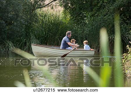 Stock Photography - Father and children on boat ride in lake. Fotosearch