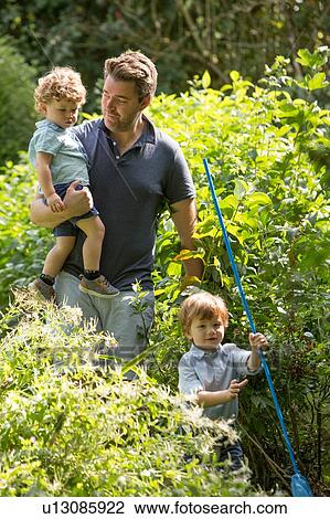 Father and children walking in park View Large Photo Image Stock Image - Father and children walking in park. Fotosearch