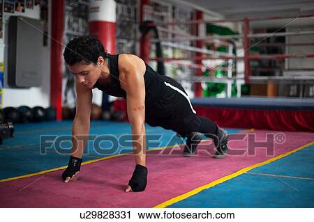 Female boxer doing planks in gym View Large Photo Image Stock Image - Female boxer doing planks in gym. Fotosearch