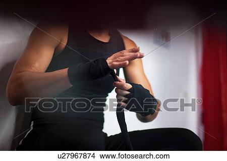 Female boxer putting on handwrap View Large Photo Image Picture - Female boxer putting on handwrap. Fotosearch