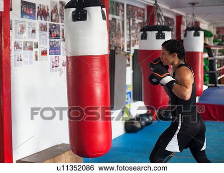 Stock Photograph - Female boxer training in gym. Fotosearch