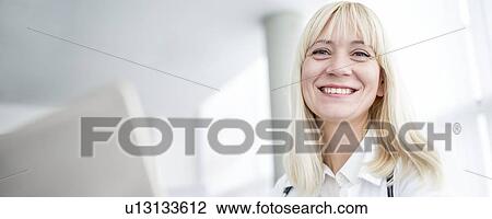 Female doctor using computer and smiling. View Large Photo Image Stock Image - Female doctor using computer and smiling.. Fotosearch