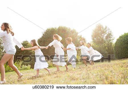 Female friends and family dancing in garden View Large Photo Image Stock Photo - Female friends and family dancing in garden. Fotosearch