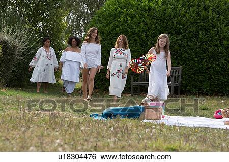 Female friends and family having picnic in garden View Large Photo Image Stock Photograph - Female friends and family having picnic in garden. Fotosearch