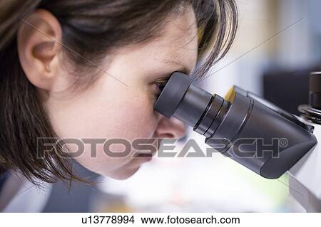 Female laboratory technician using microscope in the lab. View Large Photo Image Picture - Female laboratory technician using microscope in the lab.. Fotosearch