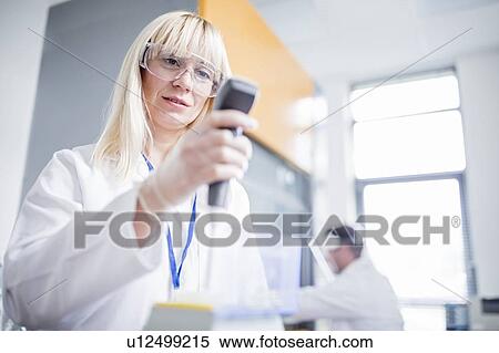 Female scientist wearing protective goggles and using device. View Large Photo Image Stock Photography - Female scientist wearing protective goggles and using device.. Fotosearch