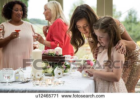 Stock Image - Female wedding guests at reception. Fotosearch