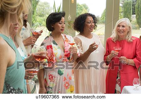 Stock Photography - Female wedding guests at reception. Fotosearch